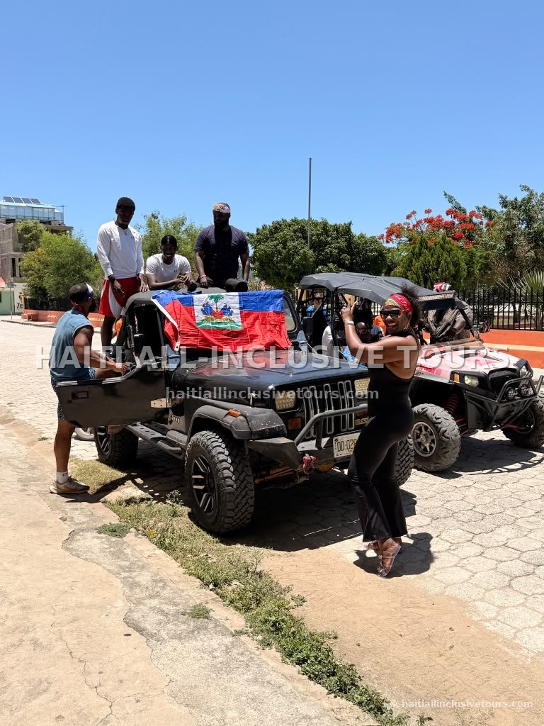 Guests preparing the 4x4 jeeps draped with the Haitian flag before an off-road excursion