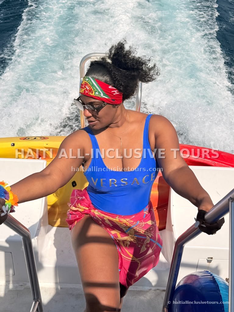 Guest stepping across the boat deck as the catamaran cruises the coast