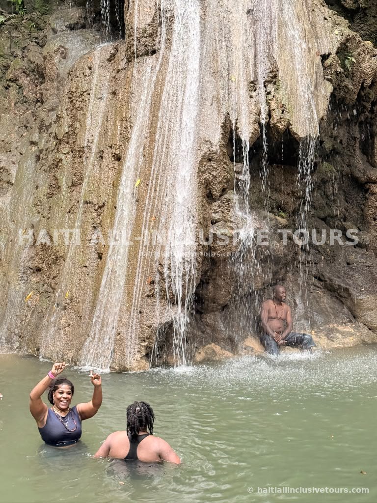 Guest cheering under the cascading waterfall during the excursion