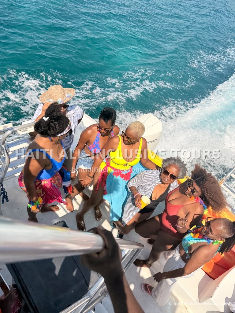 Guests dancing on the boat deck above the turquoise wake