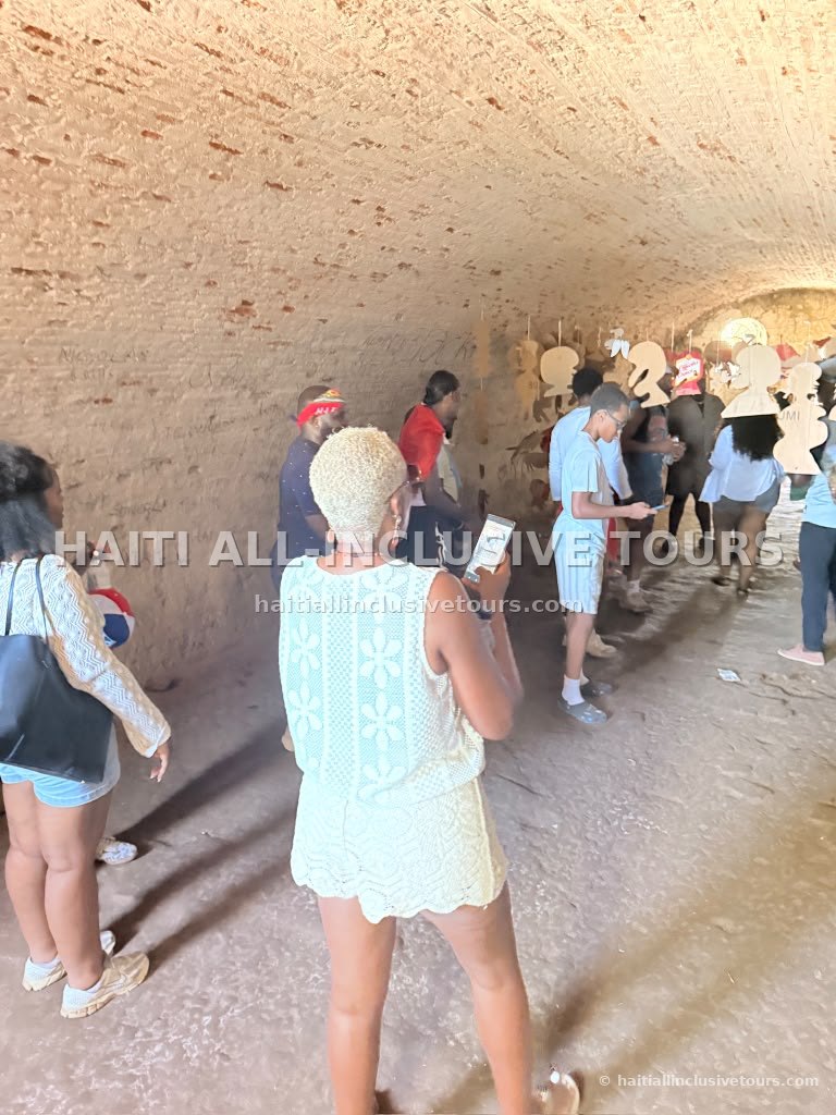 Guests walking through the fort's arched corridor during the guided history tour
