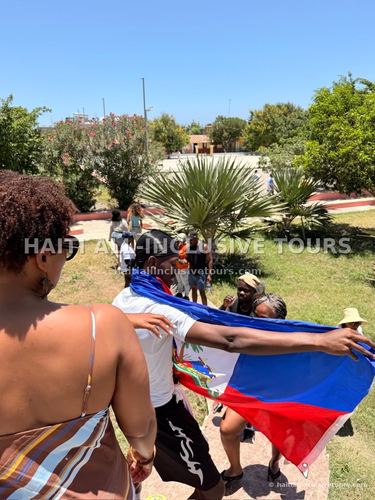 Guests holding the Haitian flag during a city walking tour