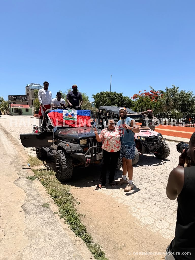 Guests posing with Haitian-flag-draped 4x4 jeeps before the off-road excursion