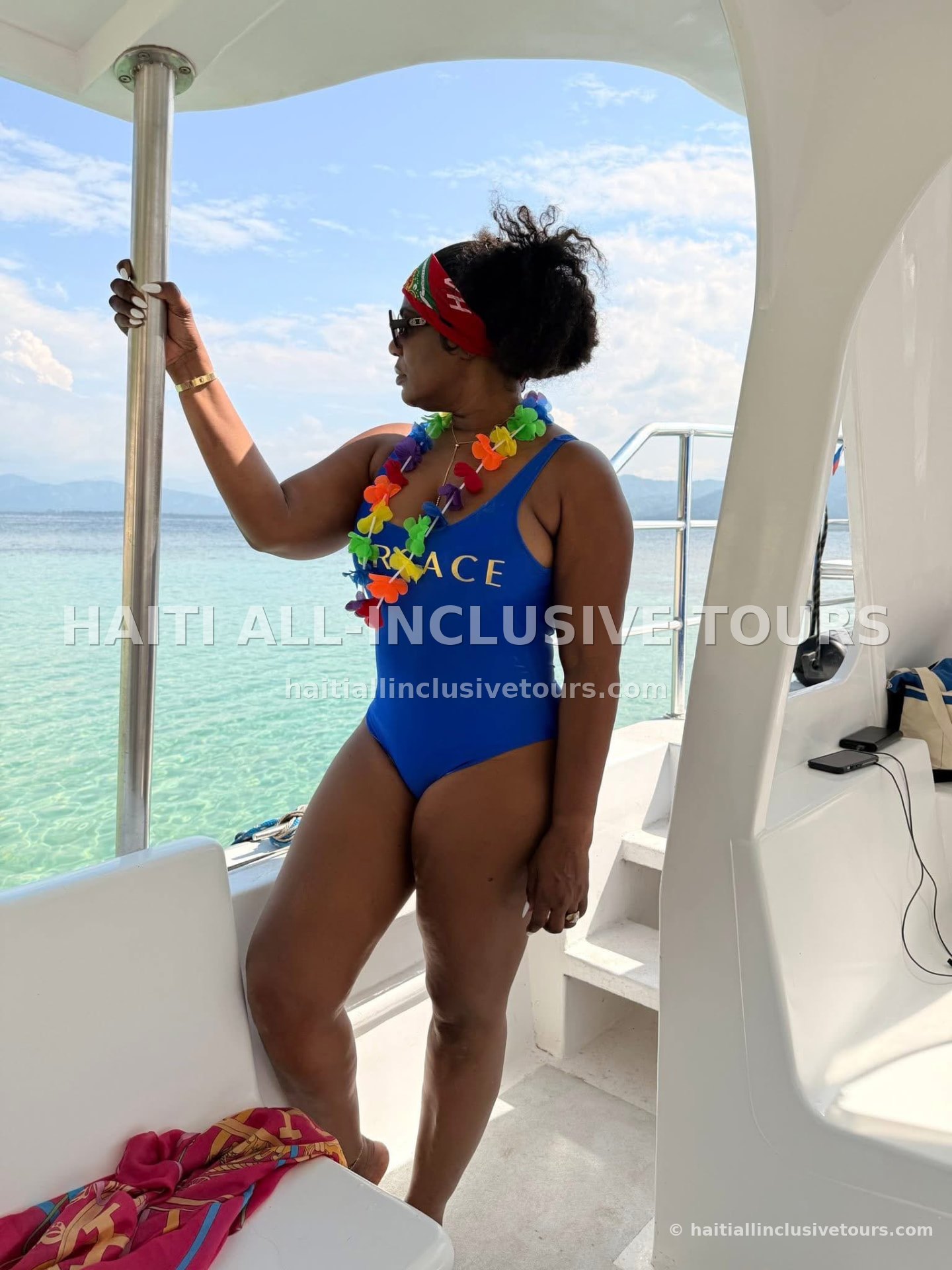 Guest on the catamaran deck over turquoise water off Cap-Haïtien