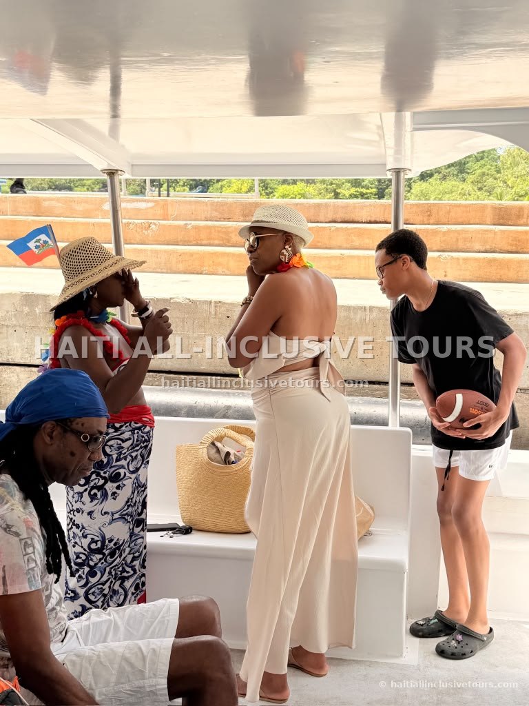 Guests chatting under the boat canopy before the catamaran excursion sets off